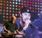 No, Luke Bryan isn't a giant - he just looks like one here, with his image projected on a big screen behind his band during his concert Feb. 21 in Fort Wayne. (Photo by Cindy Larson of The News-Sentinel) 