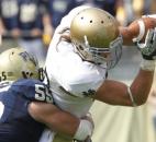 Notre Dame tight end Tyler Eifert catches a pass in front of Pittsburgh linebacker Max Gruder in the third quarter of the Irish's 15-12 victory in 2011. Eifert finished his junior seaosn with 803 receiving yards and was named a finalist for the John Mackey Award. (Photo by The Associated Press)