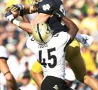 Notre Dame tight end Tyler Eifert goes up over Purdue linebacker Will Lucas for a reception deep in Boilermaker territory during Notre Dame's 20-17 win in September 2012. Eifert had a game-high 98 receiving yards in the early-season victory that helped the Irish finish the regular season undefeated. (Photo by Chad Ryan/INMedia Source)