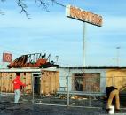 Temporary fencing was being placed around the burned-out shell of the the former Hooters on Coliseum Boulevard. The vacant structure was damaged in a fire Jan. 7.