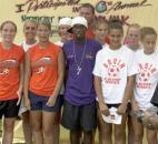 For a small fee, fans could get their picture taken with Major League Soccer star and Fort Wayne native DaMarcus Beasley at the annual AIDSWalk in 2002 at Lawton Park. The Northop High School girls soccer team, shown here, had their picture taken with Beasley prior to the walk.