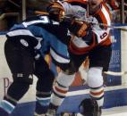 Colin Chaulk and Billy Collins of Muskegon lose their helmets during a scuffle along the boards in April 2005 at Memorial Coliseum. (News-Sentinel file photo)