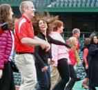 Dance leaders on the dugout at Parkview Field rocked out during the One Billion Rising event Feb. 14. The One Billion Rising campaign began as a call to action based on the statistic that one in three women on the planet will be beaten or raped during her lifetime. (Photo by Ellie Bouge of The News-Sentinel)