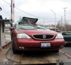 This car collided with a semi Feb. 14 near the intersection of Jefferson Boulevard and Lindenwood Avenue, after which the vehicle was placed on a flatbed trailer for towing. At least one person was taken to the hospital after the crash. (Photo by Elbert Starks III of The News-Sentinel)