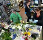 Robin Griswold and Cindy Boneff work on flower arrangements Feb. 13 at Lopshire Flowers & Gifts, 6418 E. State Blvd., as Shenoah White passes behind them. The shop was packed with customers and workers alike the afternoon before Valentine's Day. (Photo by Bob Caylor of The News-Sentinel)