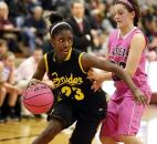 Snider's Deja Wimby, left, makes a move to get around Concordia Lutheran's Olivia Hahn during the first half of the Panthers' 62-52 win Jan. 18 at Concordia. The game was played with a pink basketball, and after the game ball was auctioned off to raise money for cancer research.