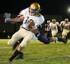 Tyler Eifert avoids Muncie Central's Ben Euliss as he crosses the goal line for Bishop Dwenger's first touchdown in a 26-24 victory against Muncie Central in the 2006 IHSAA regional championship. (News-Sentinel file photo)