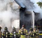 Fort Wayne firefighters apply water Jan. 24 to a burning house in the 100 block of Mechanic Street, just west of downtown. The fire, which raged for at least 45 minutes, destroyed the two-apartment house.