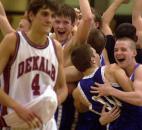 Carroll celebrates its 64-51 upset victory in the 2001 Class 4A sectional first round as DeKalb's Adam Liddell leaves the floor. DeKalb entered the state tournament following a perfect 20-0 regular season. Carroll's Scott Bushong had a game-high 18 rebounds and helped the Chargers erase a fourth-quarter deficit. 