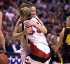 As the ball drops, Bishop Luers players Amy Frieburger and Jessica Hathaway hug after beating the Gibson Southern 51-37 for the Knights’ fourth consecutive state championship. The Knights won this state title in their first year of moving up one class to Class 3A. News-Sentinel file photo