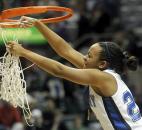 Canterbury's Paige Wells cuts down the net after the team defeated Vincennes Rivet in overtime 72-66 in the 2009 Class A state finals at Memorial Coliseum. The Cavaliers rallied from a nine-point deficit in the final five minutes of regulation to force overtime and eventually repeat as state champions. Photo by Ellie Bogue