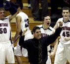 Coach Chris Hissong and several Heritage players celebrate teammate Ryan Axt's buzzer-beating tip-in as the Patriots knocked off Angola 45-44 in the first round of the 2009 Class 3A sectional. Heritage would lose in the sectional semifinals to Bishop Dwenger to end its season.