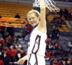 Concordia Lutheran's Lauren Marinko hoists the net in triumph after the Cadets won their second Class 3A state championship in three years with a 42-39 win against Mount Vernon in the 2012 state finals at Terre Haute. Marinko scored a game-high 17 points to help Concordia overcome a halftime deficit and win the state title. News-Sentinel file photo