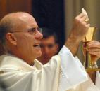 Bishop Kevin C. Rhoades performs the ritual of holy communion during Bishop John D'Arcy's funeral mass Feb. 8 at the Cathedral of the Immaculate Conception. (Photo by Ellie Bogue of The News-Sentinel)
