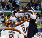 Teammates mob Colin Chaulk after he scored an overtime game-winning goal for the Komets against Muskegon in the 2008 postseason. (File photo by Ellie Bogue of The News-Sentinel)