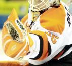 Komets goalie Kenny Reiter eyes the puck in his glove after a save in the third period of the Komets' game against the Cincinnati Cyclones on Jan. 13 at Memorial Coliseum.