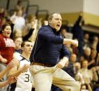Norwell coach Randy Hawkins jumps and cheers after the basket that brought his Knights back to tie Wayne late in the fourth quarter after trailing by as much as 20 points in the game Jan. 9 at Norwell. The Knights, who never led in regulation time, surged in the overtime period to beat Wayne 85-80.