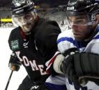 Komets captain Colin Chaulk rides Evansville defenseman Jamie Lovell into the glass deep in the offensive zone during the Komets' 4-3 overtime victory in March 2011 at Memorial Coliseum. (News-Sentinel file photo)