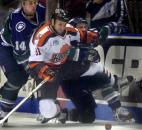 Komets center Colin Chaulk is knocked off his feet by Missouri River Otters players Joe Ritson and Dustin Whitecotton during a game in January 2003 at Memorial Coliseum. (News-Sentinel file photo)