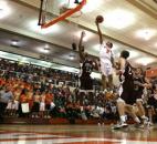 Northrop's Brenton Scott launches himself through a trio of Concordia Lutheran defenders for a fingertip layup during a Feb. 1 game at Northrop. (Photo by Chad Ryan/INMedia Source)