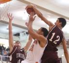 As Concordia Lutheran's Brian Gremauz closes in for the double team, D.J. McCall swats the shot of Northrop's Bryson Scott late in the second half of the Cadets' 59-58 win on Friday at Northrop. Concordia double-teamed Scott nearly the entire game, but he still led all scorers with 25 points. (Photo by Chad Ryan/INMedia Source)