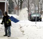 Keeghan Bullock, 9, shovels a sidewalk at Wells and Huffman streets on the morning of Feb. 22 after the previous night's snowfall. Just more than 1 inch of snow fell overnight in Fort Wayne, according to the National Weather Service. (By Christian Sheckler of The News-Sentinel)