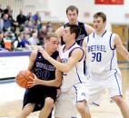 Saint Francis' Kevin Bloom tries to drive against the defense of Bethel's Zach Miller in its Crossroads League Tournament game Feb. 21. Saint Francis lost to Bethel 89-73 to finish its season 18-13. (Photo courtesy of Saint Francis athletics department)