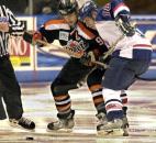 The Komets' Colin Chaulk and the Stars' B.J. Kilbourne battle for control of the puck in the second period of a 2003 game at the coliseum. (File photo by Ellie Bogue of The News-Sentinel)