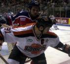 Colin Chaulk gets a grip on things, namely the stick of Kalamazoo's Jim Dube, during a 2004 postseason game at Memorial Coliseum. (News-Sentinel file photo)