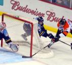 Toledo goaltender Jordan Pearce dives in to take a goal away off the stick of Komets forward Matt Syroczynski during the second period Feb. 17 in Toledo. The Komets lost the game to extend their losing streak to five games. (Photo by Blake Sebring of The News-Sentinel)