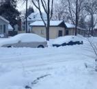 Vehicles are snowed in on a Fort Wayne city street. (Photo by Lisa Esquivel Long of The News-Sentinel)