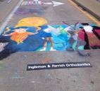 Madison Aschliman, an artist at the Fort Wayne Museum of Art's Chalk Walk at the Fort Wayne Newspapers Three Rivers Festival and junior at Snider High School, shows off her finished chalk art. Aschliman won 2nd Place in the People's Choice category.