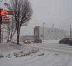 At the corner of State Boulevard and Kentucky Avenue, cars drive slowly due to a snowstorm expected to dump several inches. (Photo by Jaclyn Goldsborough of The News-Sentinel)