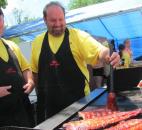 Jim McCullough (left) of Low and Slow grills alongside Dave Hart. Without revealing all that goes into the special sauce, McCullough said apples are key to the taste of the meat, as applewood is used in the smoking process.