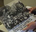 Walter “Skip” Sassmannshausen holds a photo submitted by a local resident that shows a thousand people gathering at the Baker Street Station, formally known as the Pennsylvania Railroad Station. (Photo by Jaclyn Goldsborough of The News-Sentinel)