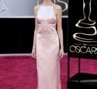 Anne Hathaway wore a blush pink Prada dress, seemingly sweet but with a strategically open back and sexy sides. (From The Associated Press)