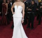 Charlize Theron was sleek in an angular, Dior Haute Couture strapless dress with a fashion-right peplum and a buzz-cut hairdo. (From The Associated Press)