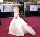 Jennifer Lawrence wore a Dior Haute Couture white-and-pale pink strapless gown with fitted bustier and poufy hemline. (From The Associated Press)