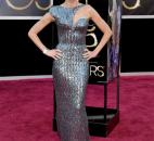 Actress Naomi Watts arrives at the Oscars in a gunmetal, beaded, Armani gown with a geometric cutout on the bodice. (From The Associated Press)
