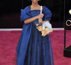 Actress Quvenzhane Wallis wears an Armani Junior navy-blue dress with black, navy and silver jewels scattered on the skirt and a big bow on the back. (From The Associated Press)