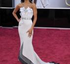 Zoey Saldana's gown had intricate detailing at the bust and an eye-catching finish at the hem. (From The Associated Press)
