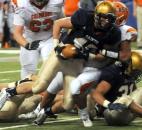 Columbus East's Markell Jones tries to put the brakes on Bishop Dwenger's  Zachary Archer during the third quarter of play.