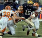 In the second quarter of play Bishop Dwenger's quarterback Mike Fiacable runs the ball for a few yards before the Columbus East's defense brought him down.
