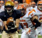 Bishop Dwenger's Gus Schrader  catches a pass from quarterback Mike Fiacable in the third quarter of play. 