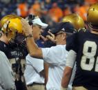 Bishop Dwenger's  Chris Svarczkopf, head coach,  gives a player a little encouragement during the third quarter.