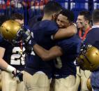 Marcus Stepp comforts Antonio Blackmon after Bishop Dwenger fell to Columbus East Saturday. Bishop Dwenger lost to Columbus East 27-28 at the Class 4A IHSAA Football finals at Lucas Oil Stadium.