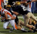 The Bishop Dwenger defense tries to put the brakes on  Columbus East's quarterback,  Alex Cowan, during the second quarter.