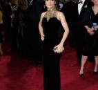 Salma Hayek's midnight-blue velvet Alexander McQueen gown had a gold embellished collar, and she carried a gold skull box clutch. (From The Associated Press)