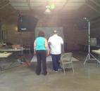 Peggy Bender, education and outreach specialist at Animal Care and Control, works with Jim McKinley of McKinley Photography for the Picture Your Pet event. (Photo by Jaclyn Goldsborough)