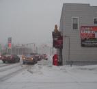 Outside Klemm's Candlelight Cafe, 1207 E. State Blvd., snow begins to fall as commuters head home Monday evening. (Photo by Jaclyn Goldsborough of The News-Sentinel)